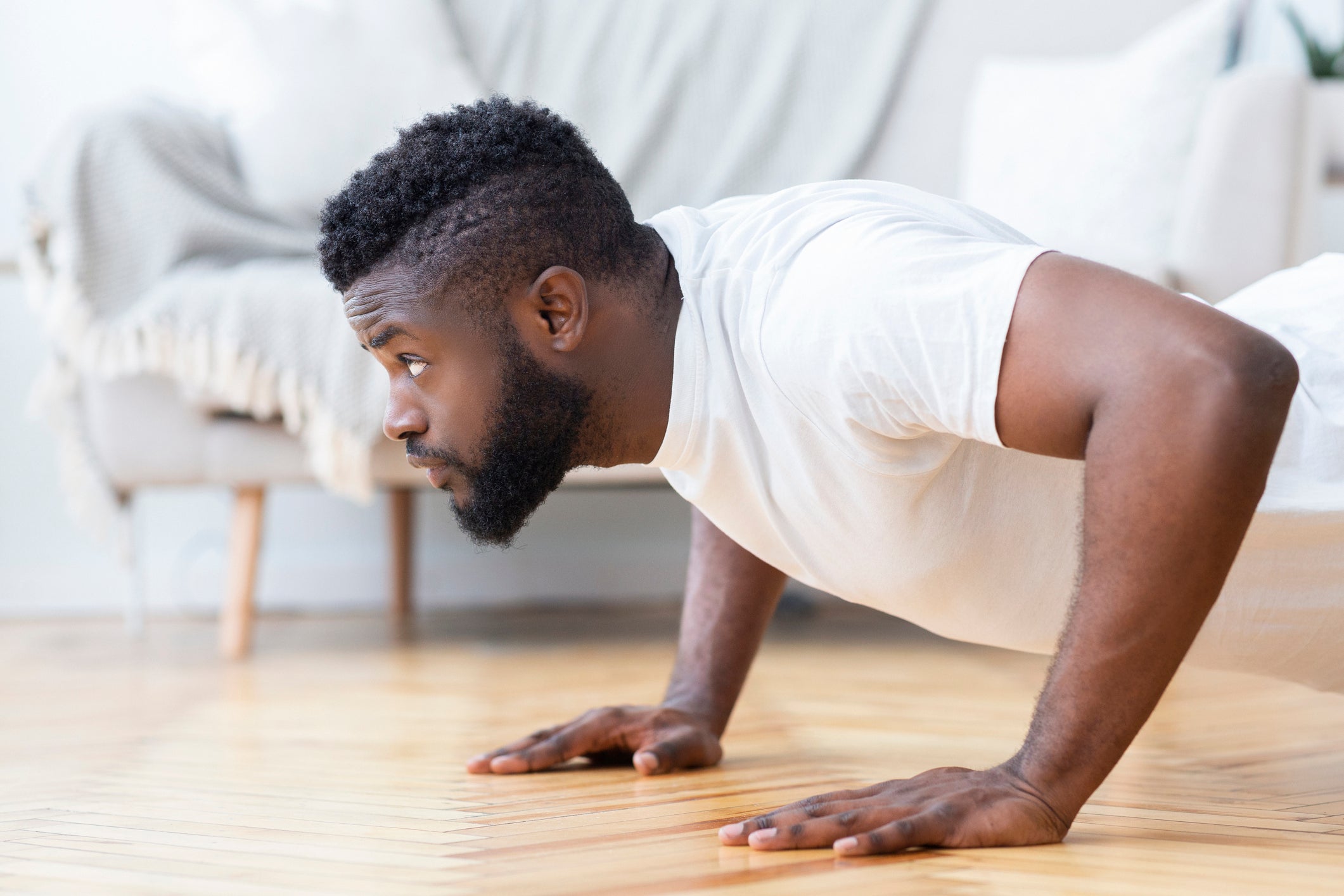 man doing resistance training at home